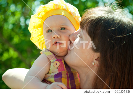 Happy mother kissing baby daughter 9210486