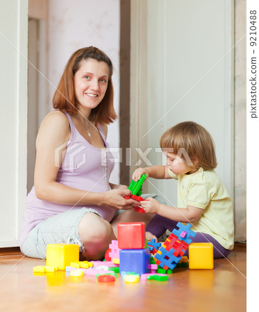 pregnant mother plays with child 9210488