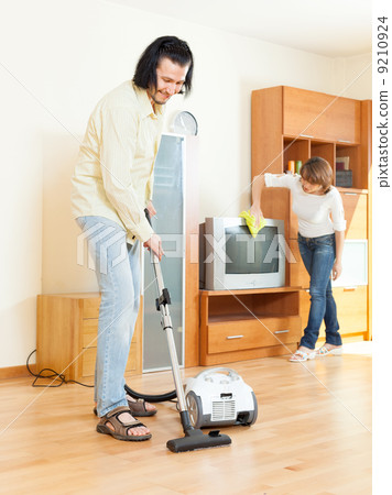Happy middle-aged couple doing housework Happy middle-aged couple doing housework 9210924