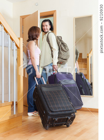 wonderful couple together with their luggage leaving home wonderful couple together with their luggage leaving home 9210930