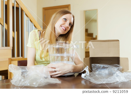 Happy woman with new electric steamer Happy woman with new electric steamer 9211059