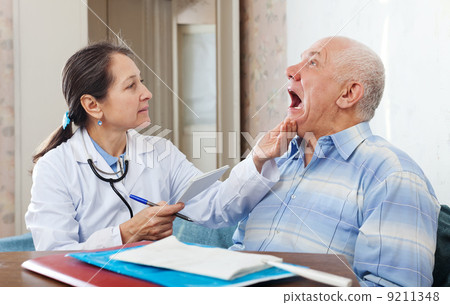 mature doctor looks the mouth of patient mature doctor looks the mouth of patient 9211348