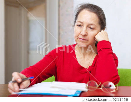 serious woman reads documents serious woman reads documents 9211456