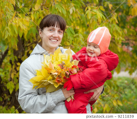 Happy mother with baby in autumn 9211839