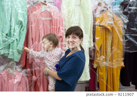 Happy woman and child chooses clothes 9211907