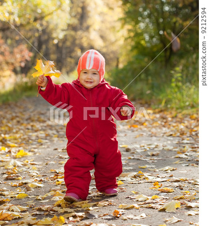 Happy toddler in autumn park Happy toddler in autumn park 9212594