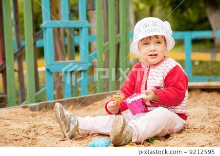 two-year child playing with sand two-year child playing with sand 9212595