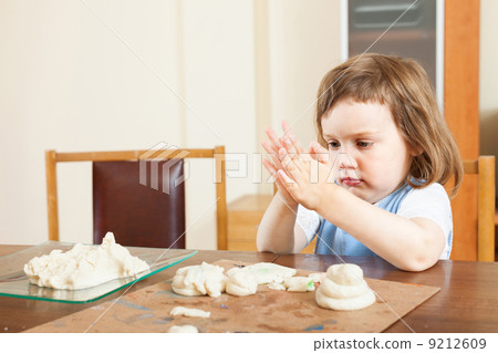 The child makes dough figurines The child makes dough figurines 9212609