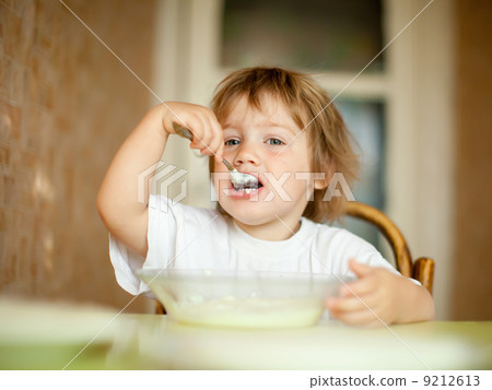 child eats with spoon child eats with spoon 9212613