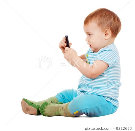 Toddler using mobile phone Toddler using mobile phone 9212653