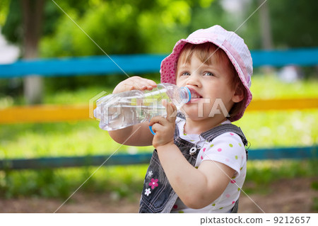 child drinks from plastic bottle child drinks from plastic bottle 9212657