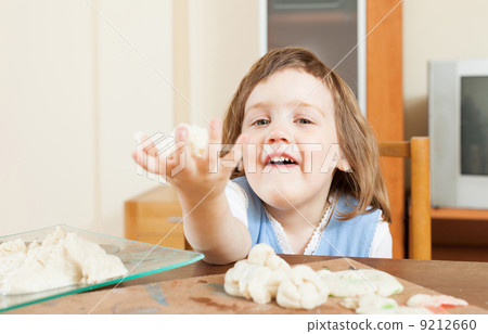 Baby girl sculpting from clay or dough in home Baby girl sculpting from clay or dough in home 9212660