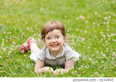 happy three year girl in grass meadow happy three year girl in grass meadow 9212668