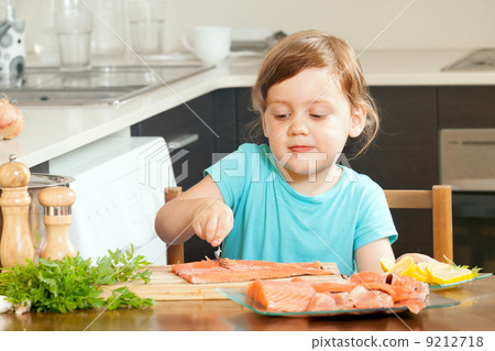 Baby housewife cooking salmon 9212718