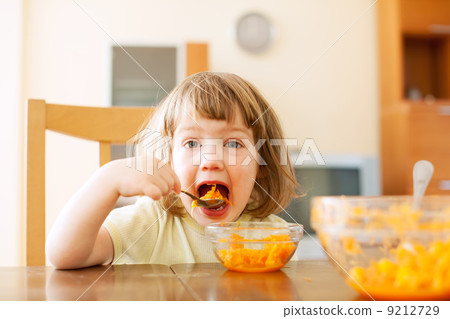 Little girl eating carrot salad 9212729