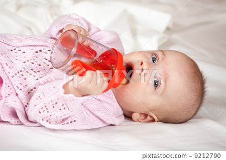Baby girl with sippy cup Baby girl with sippy cup 9212790