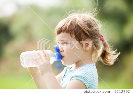 child drinking from plastic bottle child drinking from plastic bottle 9212792