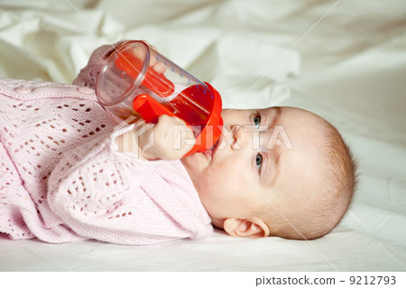 Baby girl with sippy cup Baby girl with sippy cup 9212793