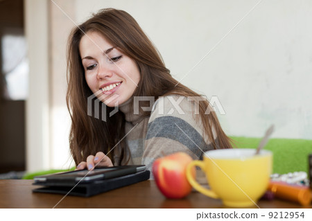 woman reads e-book in home 9212954