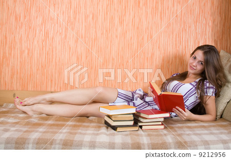 girl reading book on sofa girl reading book on sofa 9212956