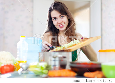 woman cooking vegetarian dinner woman cooking vegetarian dinner 9212959