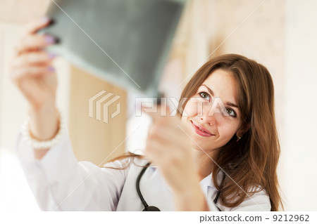 Friendly doctor looks x-ray Friendly doctor looks x-ray 9212962