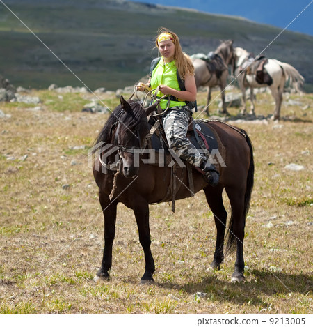 tourist with backpack on horseback 9213005