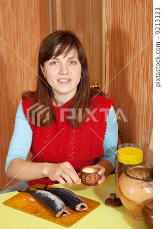 woman salting mackerel fish woman salting mackerel fish 9213123