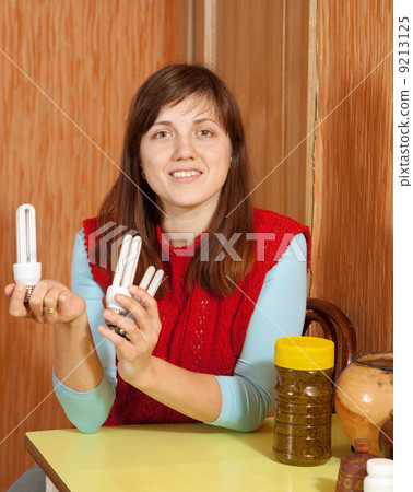 Girl holding energy saving bulbs Girl holding energy saving bulbs 9213125