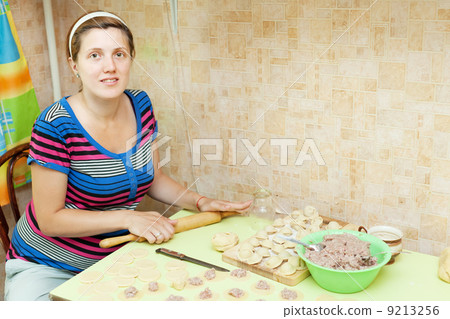 Woman making russian meat dumplings Woman making russian meat dumplings 9213256