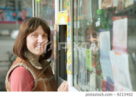 Young woman near newsstand 9213402