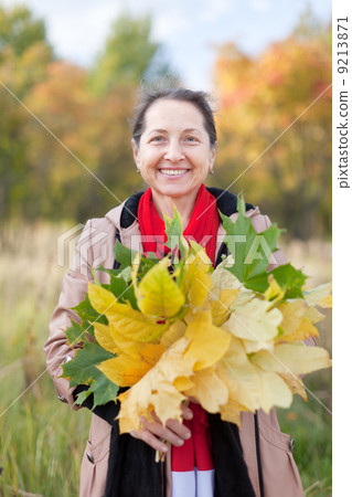 Outdoor portrait of happy mature woman 9213871