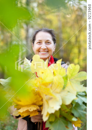 mature woman in autumn park mature woman in autumn park 9213968