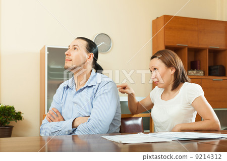 woman asking for money from husband for the purchase 9214312