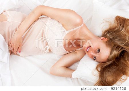 Pretty pregnancy woman wakes up in her bed 9214528