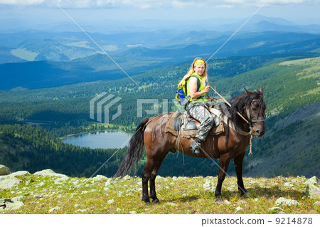 Female rider at mountains Female rider at mountains 9214878
