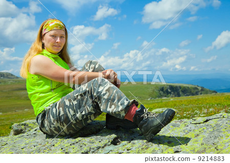 Woman sitting on stone 9214883