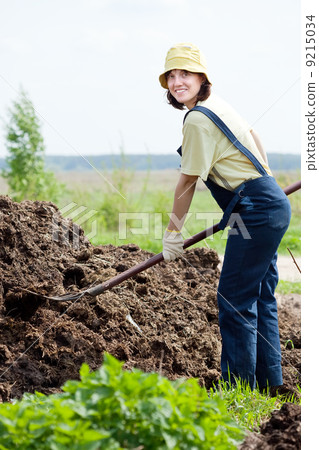 Woman works with animal manure 9215034
