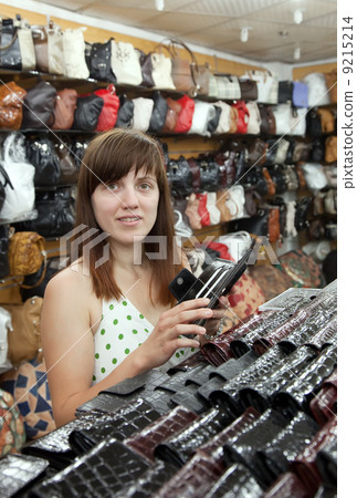 woman chooses leather wallet 9215214