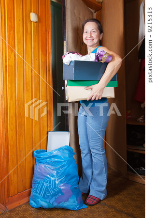 woman taking away the garbage woman taking away the garbage 9215313