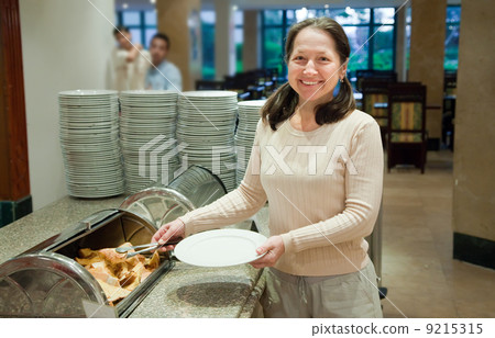 Woman takes fresh crouton Woman takes fresh crouton 9215315
