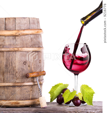 Red wine, glass and barrel with grapes 9216778