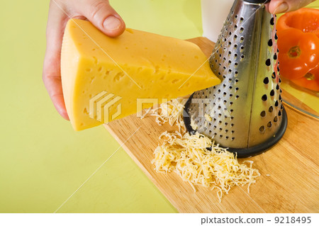 Closeup of cook grating cheese Closeup of cook grating cheese 9218495