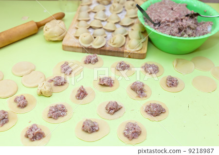 Rolling pin, dough and raw pelmeni Rolling pin, dough and raw pelmeni 9218987