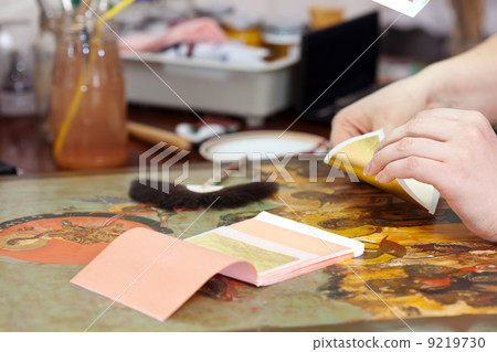 Restorer gilding on the old icon 9219730