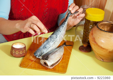 Closeup of woman is salting mackerel 9221060