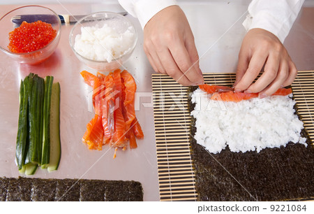 cook making sushi rolls with salmon cook making sushi rolls with salmon 9221084