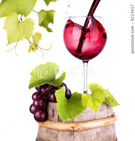 grapes and wine glass on a wooden vintage barrel grapes and wine glass on a wooden vintage barrel 9223417