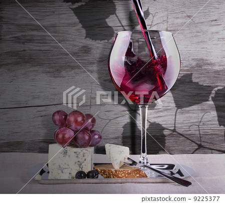 grapes with wine glass and cheese 9225377
