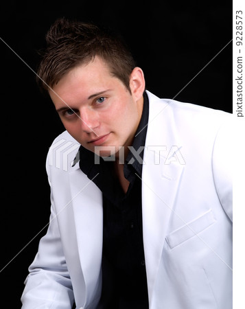 Portrait of young businessman over black background Portrait of young businessman over black background 9228573